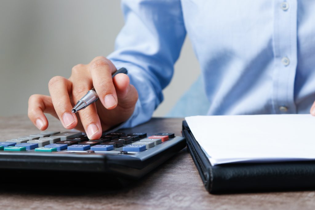 closeup of accountant using calculator
